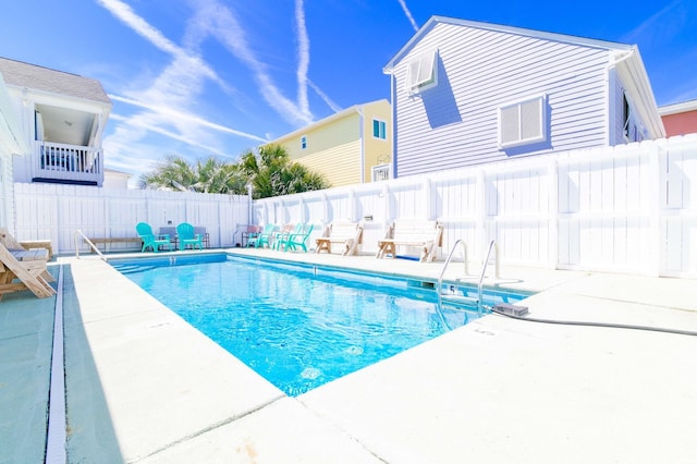 view of swimming pool with a fenced backyard, a patio area, and a fenced in pool