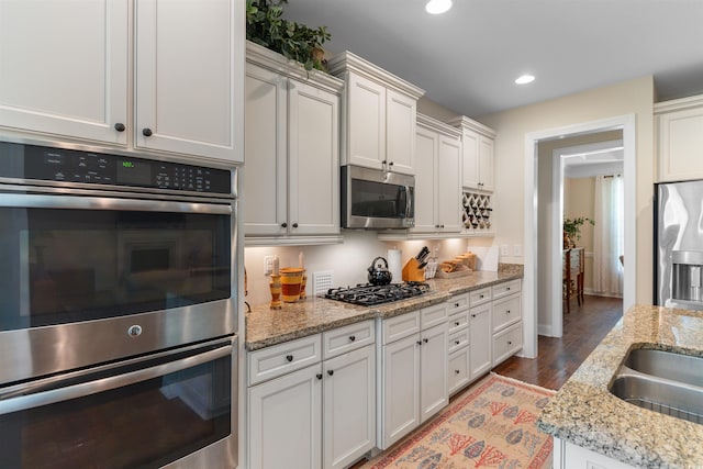 2089 Suncrest Dr, Myrtle Beach, SC 29577 - kitchen featuring light stone counters, stainless steel appliances, recessed lighting, white cabinetry, and wood finished floors