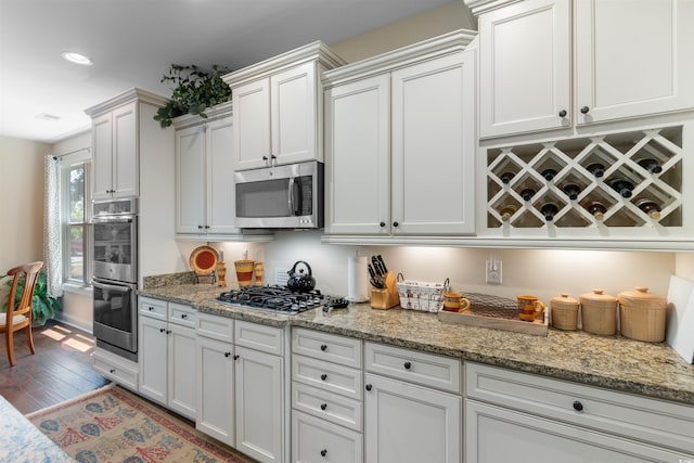 2089 Suncrest Dr, Myrtle Beach, SC 29577 - kitchen with wood finished floors, light stone countertops, and stainless steel appliances