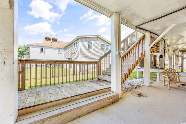 wooden deck featuring a patio area, stairway, and fence