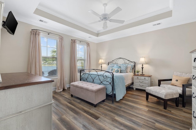 179 Hyacinth Loop, Murrells Inlet, SC 29576 - bedroom featuring crown molding, visible vents, a raised ceiling, and dark wood-type flooring