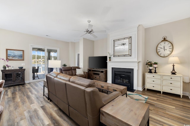 179 Hyacinth Loop, Murrells Inlet, SC 29576 - living room featuring wood finished floors, baseboards, ceiling fan, and a glass covered fireplace