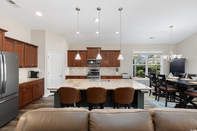 179 Hyacinth Loop, Murrells Inlet, SC 29576 - kitchen with stainless steel appliances, a breakfast bar, visible vents, open floor plan, and decorative backsplash