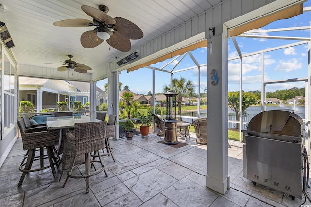 179 Hyacinth Loop, Murrells Inlet, SC 29576 - view of patio / terrace featuring area for grilling, outdoor dining area, ceiling fan, a water view, and glass enclosure
