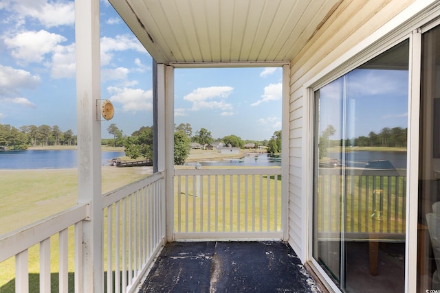 unfurnished sunroom featuring a wealth of natural light and a water view