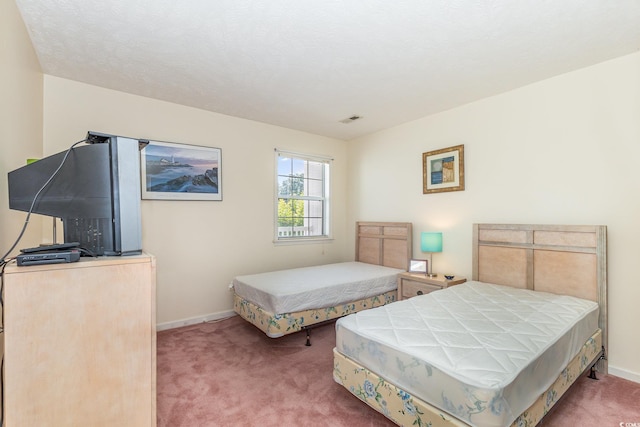 bedroom with light carpet, baseboards, and visible vents