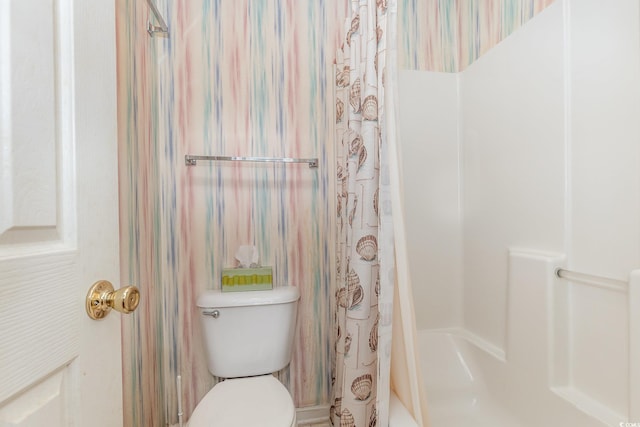 bathroom with toilet and curtained shower
