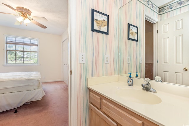 bathroom with vanity, baseboards, and a ceiling fan