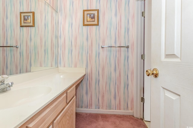 bathroom with baseboards and vanity