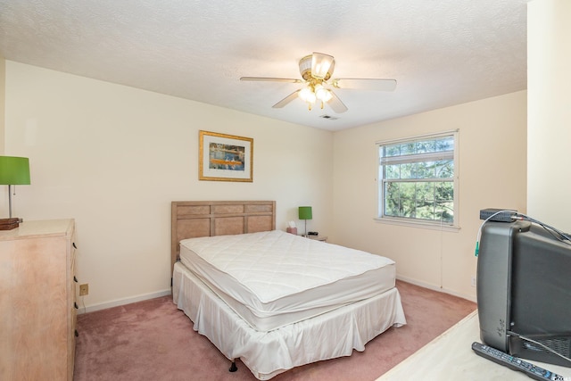 bedroom with light colored carpet, baseboards, ceiling fan, and visible vents