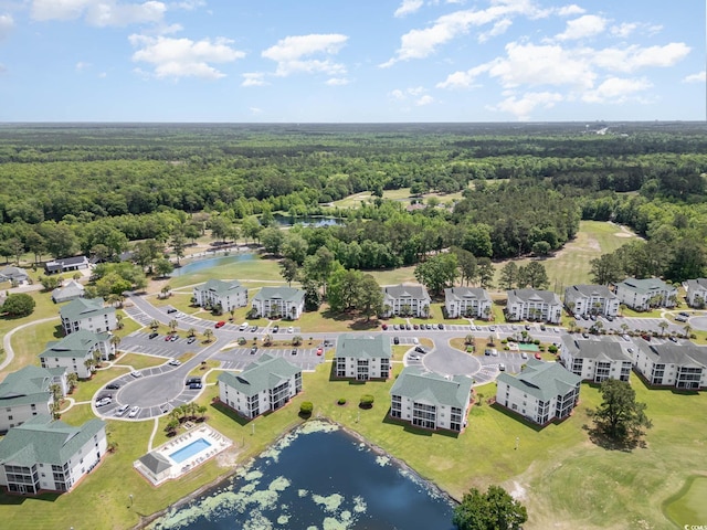 birds eye view of property featuring a water view and a forest view