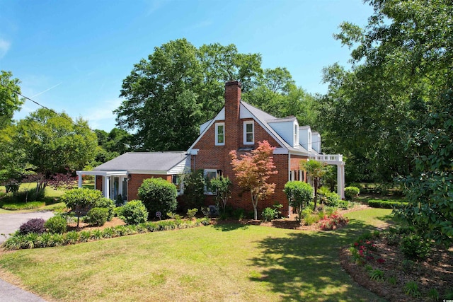 402 E Broad St, Hemingway, SC 29554 - view of home's exterior with brick siding, a yard, and a chimney