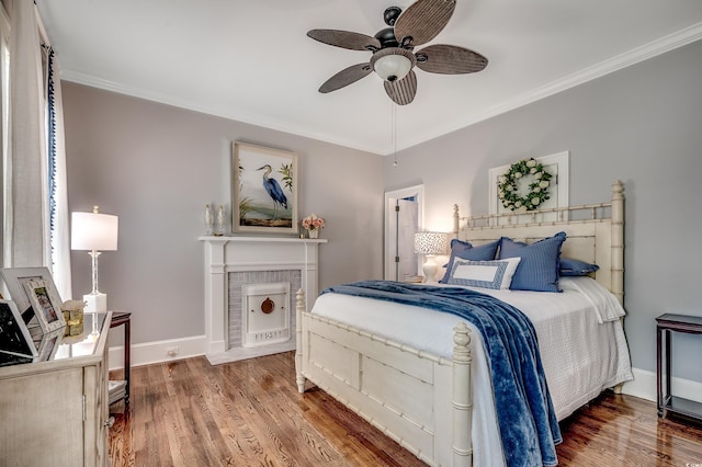 402 E Broad St, Hemingway, SC 29554 - bedroom featuring crown molding, wood finished floors, baseboards, and a ceiling fan