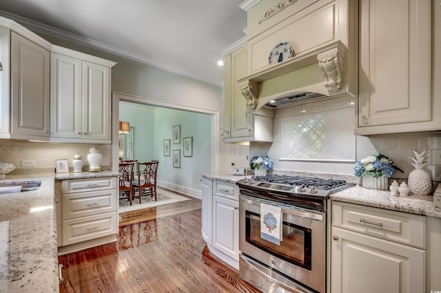 402 E Broad St, Hemingway, SC 29554 - kitchen featuring gas range, decorative backsplash, wood finished floors, ornamental molding, and light stone countertops