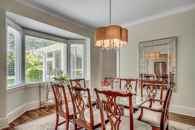 402 E Broad St, Hemingway, SC 29554 - dining room with crown molding, baseboards, wood finished floors, and a chandelier