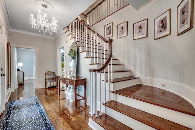 402 E Broad St, Hemingway, SC 29554 - stairs featuring wood finished floors, crown molding, and a chandelier