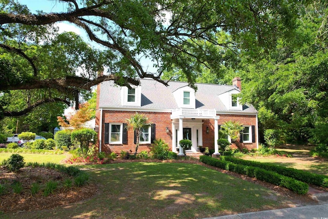 402 E Broad St, Hemingway, SC 29554 - cape cod house featuring brick siding, a chimney, and a front yard