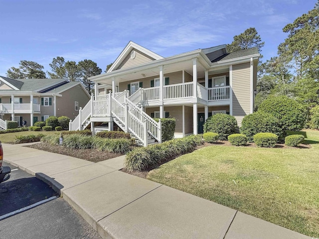 1041 Blue Stem Dr Unit 37A, Pawleys Island, SC 29585 - view of front of house with a porch, a front yard, and stairway
