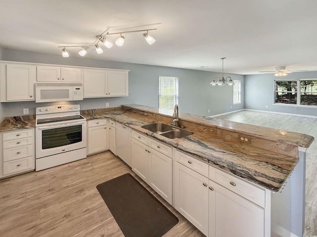 1041 Blue Stem Dr Unit 37A, Pawleys Island, SC 29585 - kitchen with white appliances, a sink, a peninsula, light wood finished floors, and a chandelier