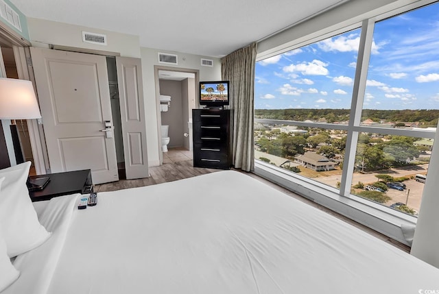 107 S Ocean Blvd Unit 1001, Myrtle Beach, SC 29577 - bedroom with visible vents and wood finished floors