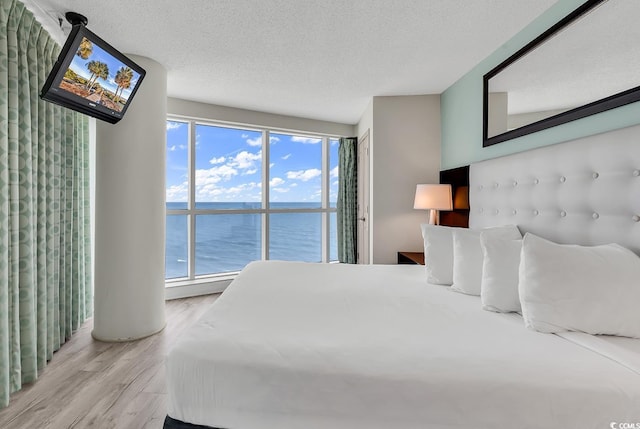 107 S Ocean Blvd Unit 1001, Myrtle Beach, SC 29577 - bedroom with a textured ceiling and wood finished floors