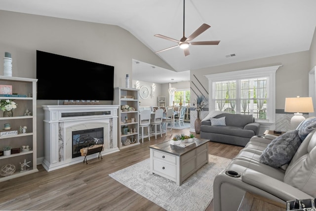 804 Twickenham Loop, Longs, SC 29568 - living room with light wood-type flooring, visible vents, ceiling fan, lofted ceiling, and a high end fireplace