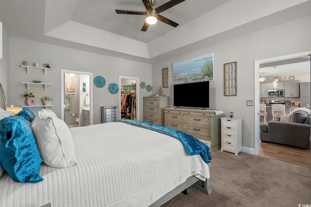 804 Twickenham Loop, Longs, SC 29568 - bedroom with a closet, light colored carpet, a tray ceiling, a walk in closet, and connected bathroom