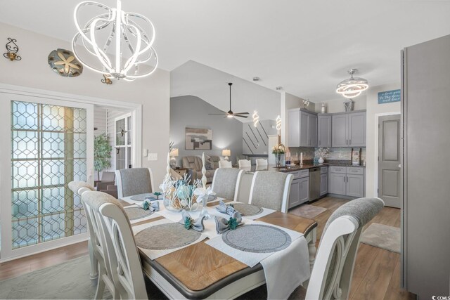 804 Twickenham Loop, Longs, SC 29568 - dining space featuring light wood finished floors, ceiling fan with notable chandelier, and vaulted ceiling