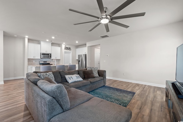 4609 Day Lily Run St, Myrtle Beach, SC 29579 - living room featuring a ceiling fan, light wood finished floors, baseboards, and recessed lighting