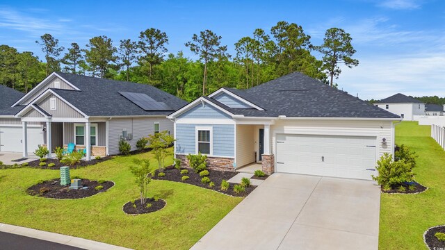 4609 Day Lily Run St, Myrtle Beach, SC 29579 - view of front of home featuring an attached garage, concrete driveway, stone siding, and a shingled roof