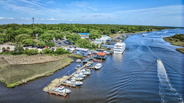 aerial view with a wooded view and a water view