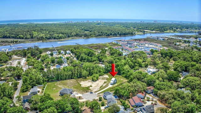 aerial view with a water view and a forest view