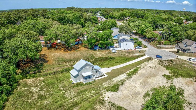birds eye view of property featuring a view of trees and a residential view