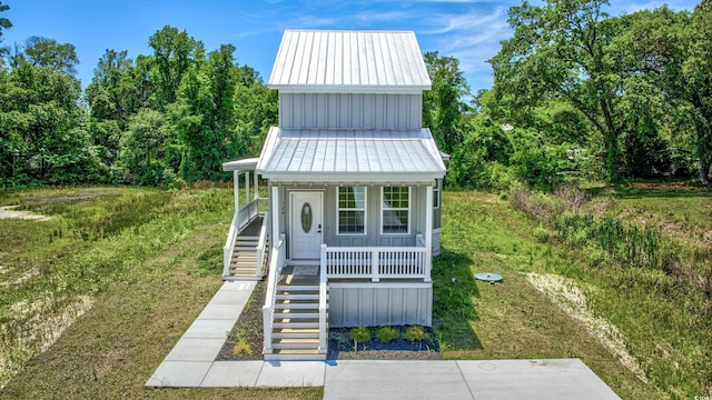 view of outbuilding featuring stairway and a porch