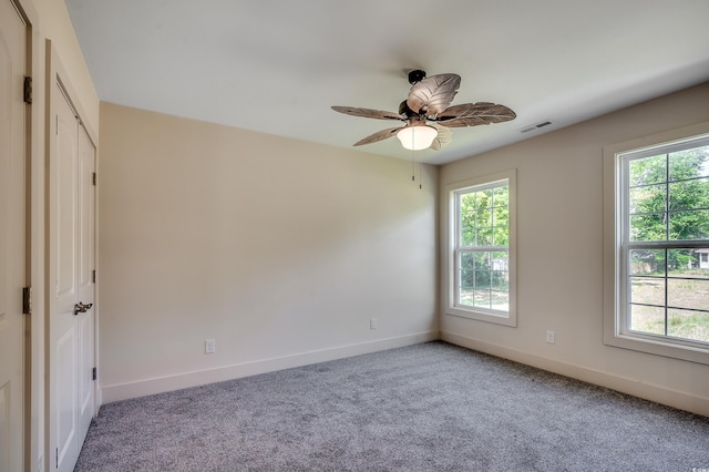 empty room with plenty of natural light, baseboards, and visible vents