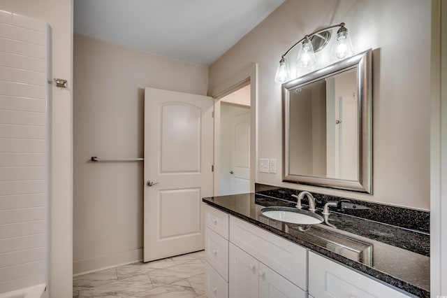 bathroom with baseboards, marble finish floor, and vanity