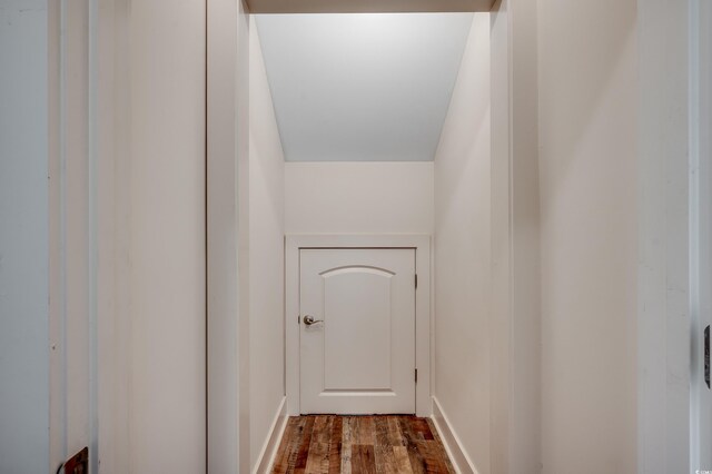 interior space with dark wood-style flooring and baseboards