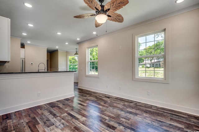 interior space featuring crown molding, baseboards, ceiling fan, and recessed lighting