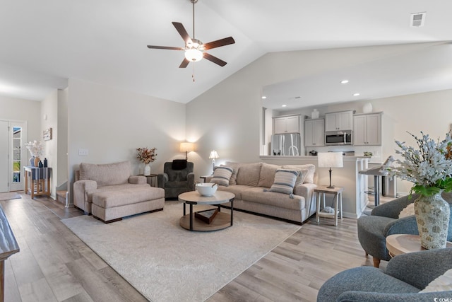 living area with lofted ceiling, light wood-style flooring, recessed lighting, visible vents, and ceiling fan