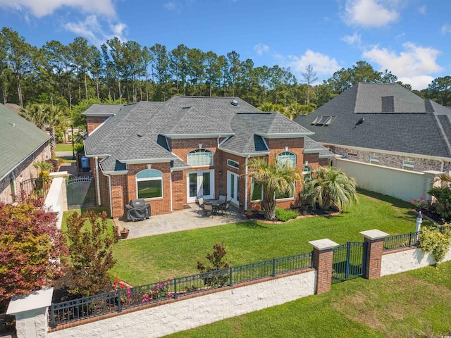 220 Waterfall Cir, Little River, SC 29566 - back of house featuring a yard, brick siding, and a gate