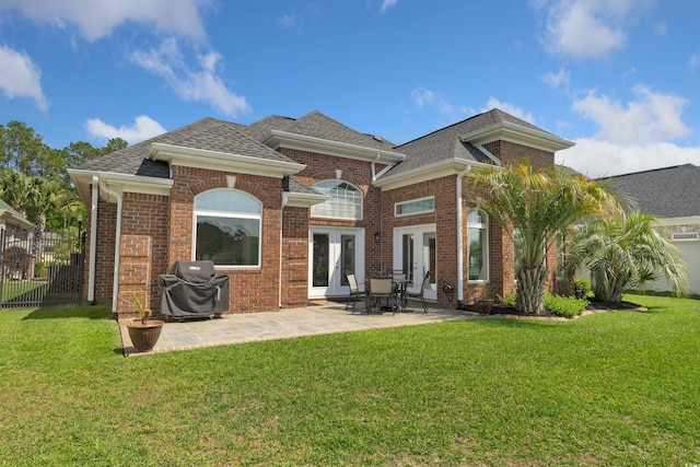220 Waterfall Cir, Little River, SC 29566 - back of house featuring roof with shingles, brick siding, french doors, and fence