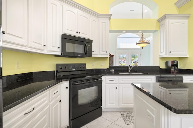 220 Waterfall Cir, Little River, SC 29566 - kitchen with dark stone countertops, a sink, white cabinets, black appliances, and light tile patterned flooring