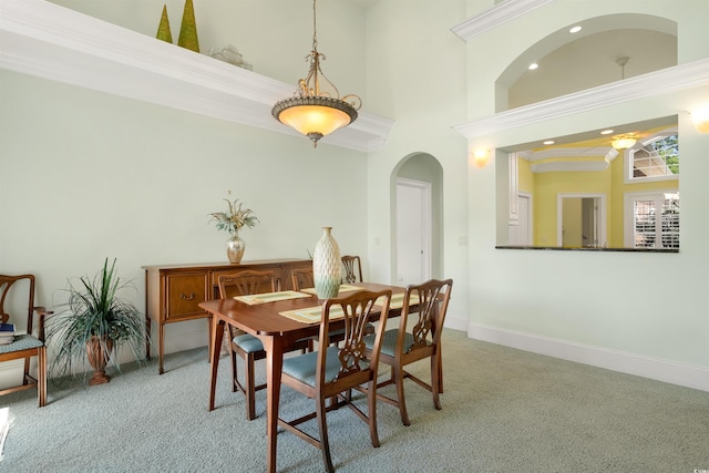 220 Waterfall Cir, Little River, SC 29566 - dining space featuring light colored carpet, a high ceiling, baseboards, and arched walkways