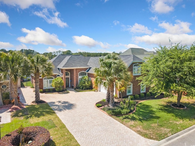 220 Waterfall Cir, Little River, SC 29566 - view of front of property featuring roof with shingles, brick siding, a front lawn, and decorative driveway
