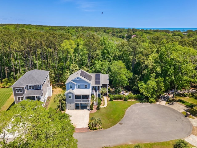 birds eye view of property featuring a wooded view