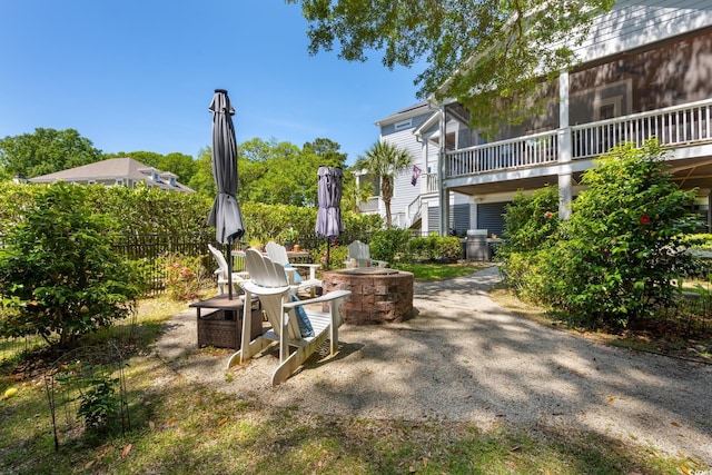 view of home's community featuring a fire pit and fence