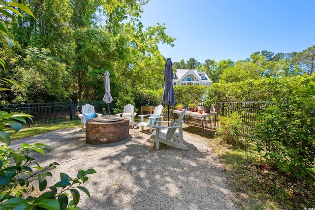 view of patio with a fire pit and fence