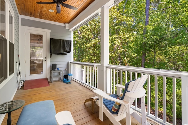wooden terrace featuring ceiling fan