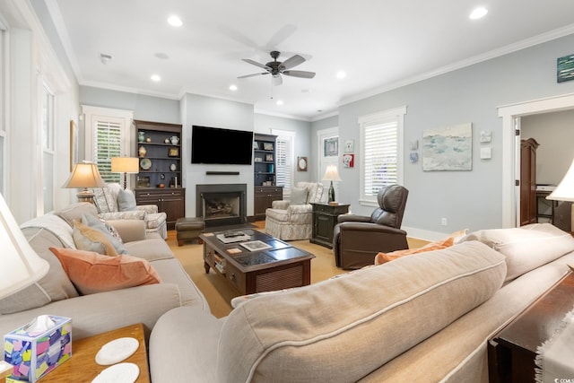 living room with recessed lighting, a fireplace, ceiling fan, and a wealth of natural light