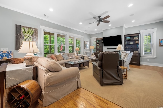 living room featuring ornamental molding, light wood-type flooring, visible vents, recessed lighting, and ceiling fan